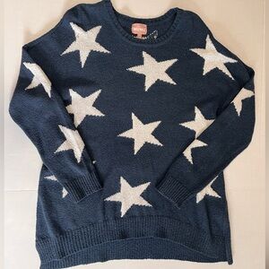 Oversized Show Me Your Mumu sweater with stars.